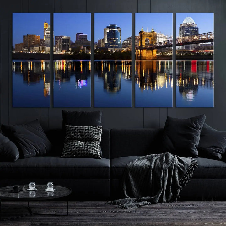 The Cincinnati City Lights Night Skyline Cityscape View Wall Art Canvas Print showcases a cityscape at night reflecting on water. It is crafted on museum-quality canvases with a UV-protective coating.