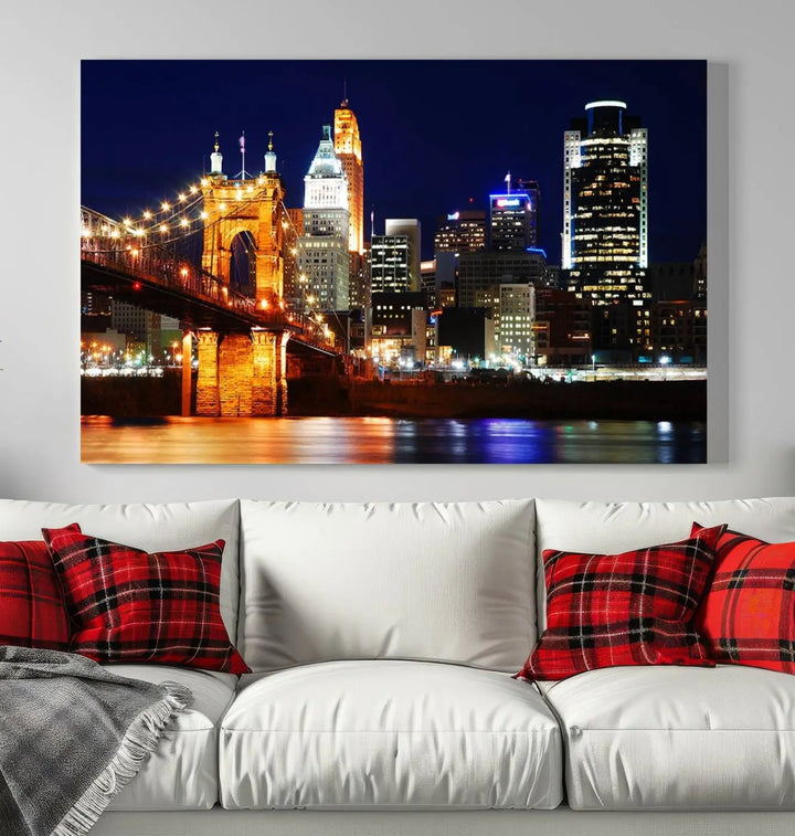 The Cincinnati City Lights Night Skyline Cityscape View Wall Art Canvas Print showcases a stunning night view of a city skyline with an illuminated bridge, making it an ideal museum-quality addition.