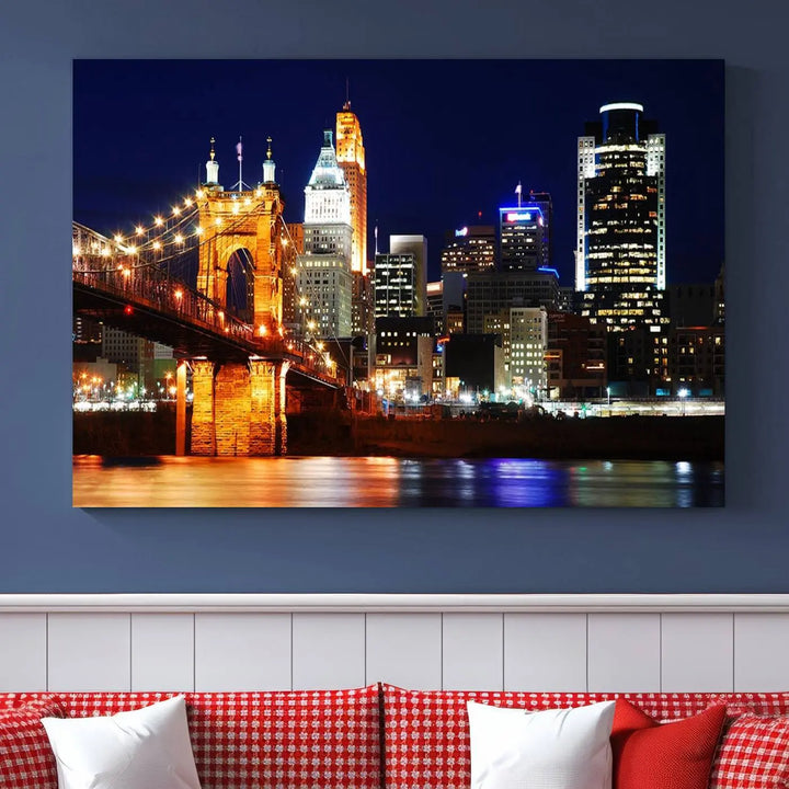 The Cincinnati City Lights Night Skyline Cityscape View Wall Art Canvas Print showcases a stunning night view of a city skyline with an illuminated bridge, making it an ideal museum-quality addition.