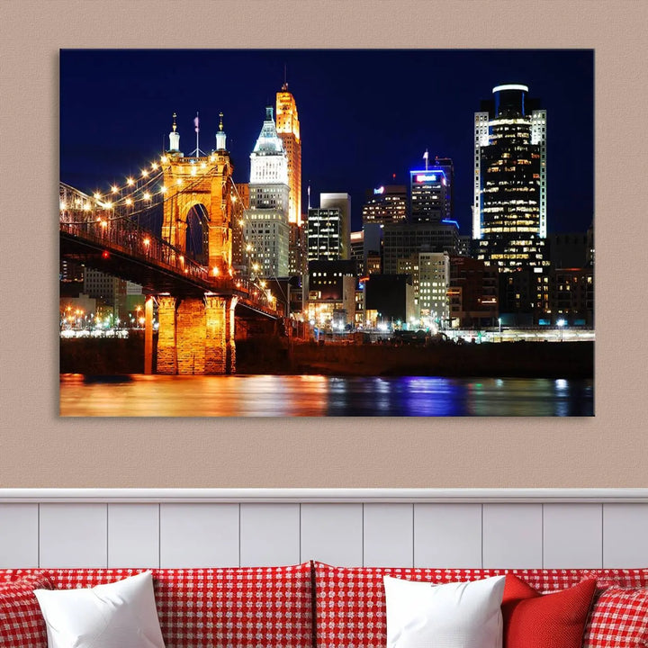 The Cincinnati City Lights Night Skyline Cityscape View Wall Art Canvas Print showcases a stunning night view of a city skyline with an illuminated bridge, making it an ideal museum-quality addition.