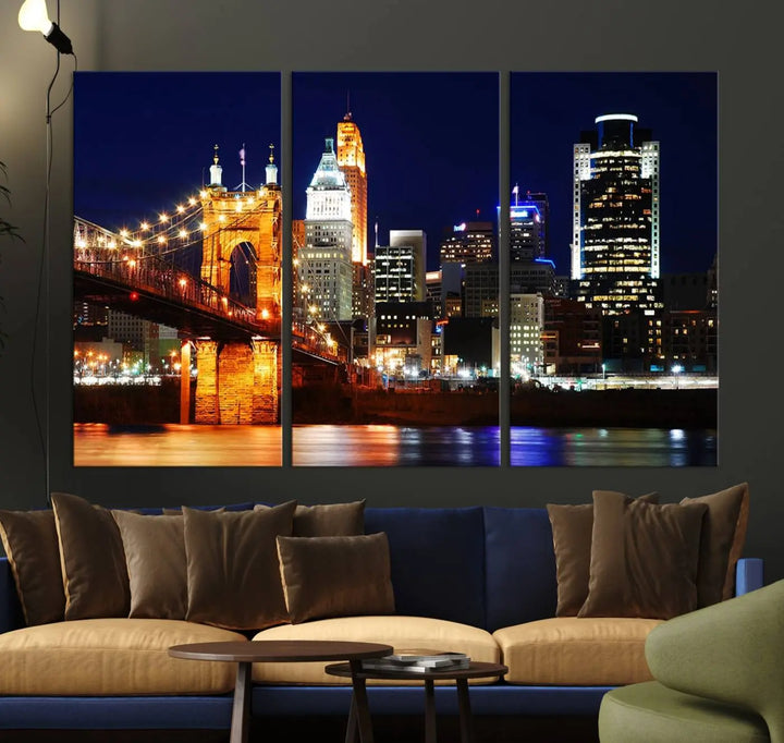 The Cincinnati City Lights Night Skyline Cityscape View Wall Art Canvas Print showcases a stunning night view of a city skyline with an illuminated bridge, making it an ideal museum-quality addition.