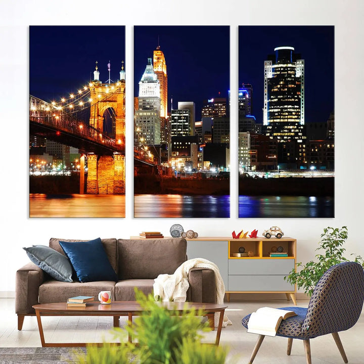 The Cincinnati City Lights Night Skyline Cityscape View Wall Art Canvas Print showcases a stunning night view of a city skyline with an illuminated bridge, making it an ideal museum-quality addition.