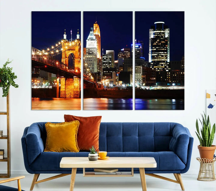 The Cincinnati City Lights Night Skyline Cityscape View Wall Art Canvas Print showcases a stunning night view of a city skyline with an illuminated bridge, making it an ideal museum-quality addition.