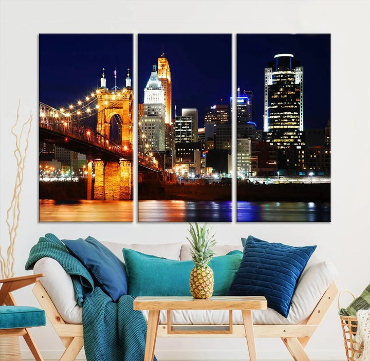 The Cincinnati City Lights Night Skyline Cityscape View Wall Art Canvas Print showcases a stunning night view of a city skyline with an illuminated bridge, making it an ideal museum-quality addition.