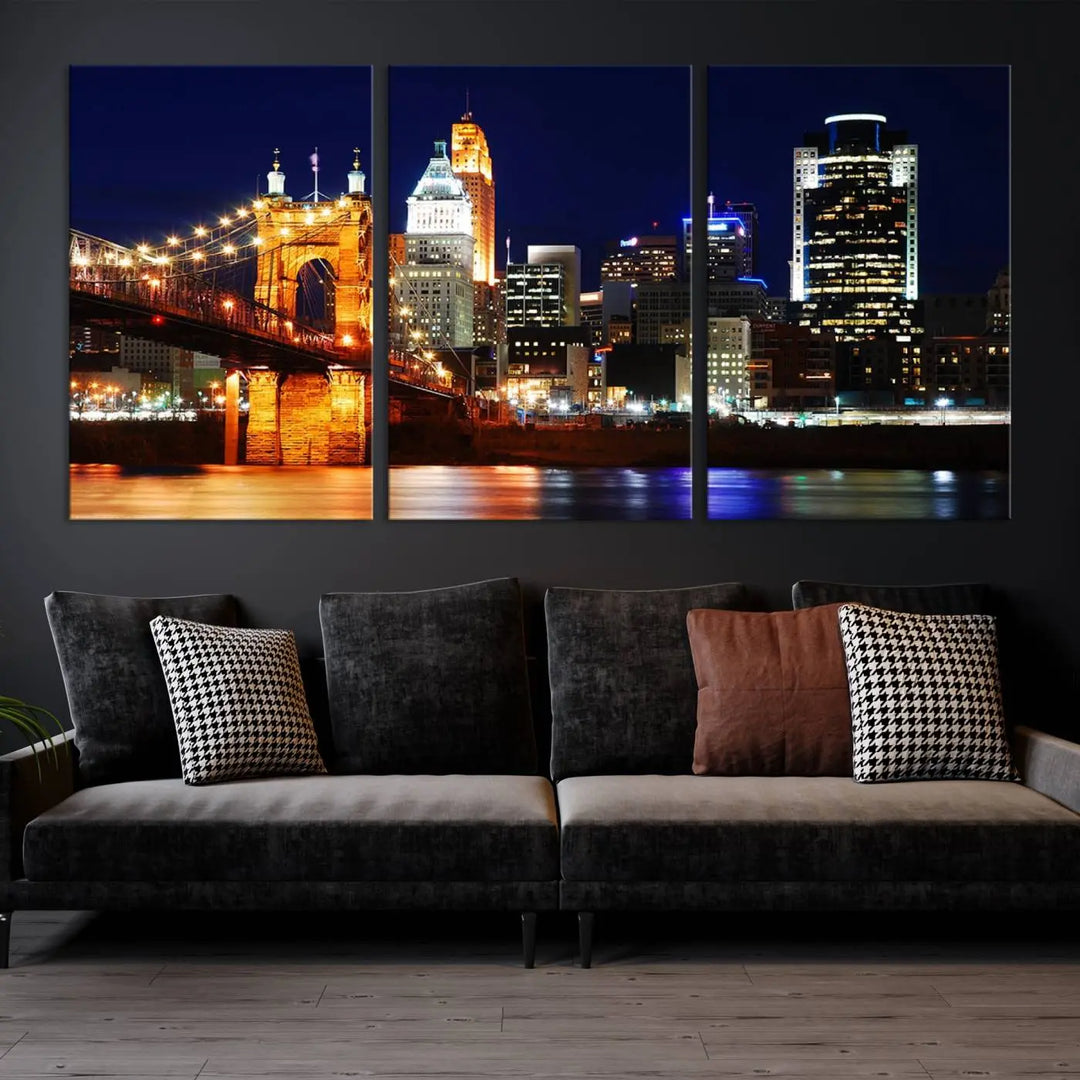 The Cincinnati City Lights Night Skyline Cityscape View Wall Art Canvas Print showcases a stunning night view of a city skyline with an illuminated bridge, making it an ideal museum-quality addition.