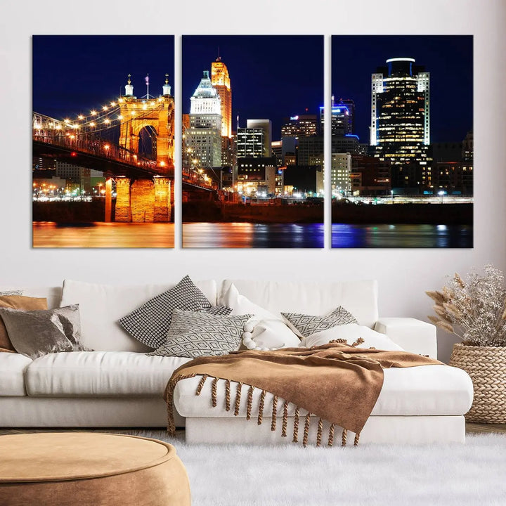 The Cincinnati City Lights Night Skyline Cityscape View Wall Art Canvas Print showcases a stunning night view of a city skyline with an illuminated bridge, making it an ideal museum-quality addition.