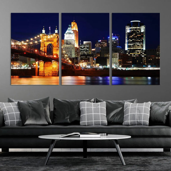 The Cincinnati City Lights Night Skyline Cityscape View Wall Art Canvas Print showcases a stunning night view of a city skyline with an illuminated bridge, making it an ideal museum-quality addition.