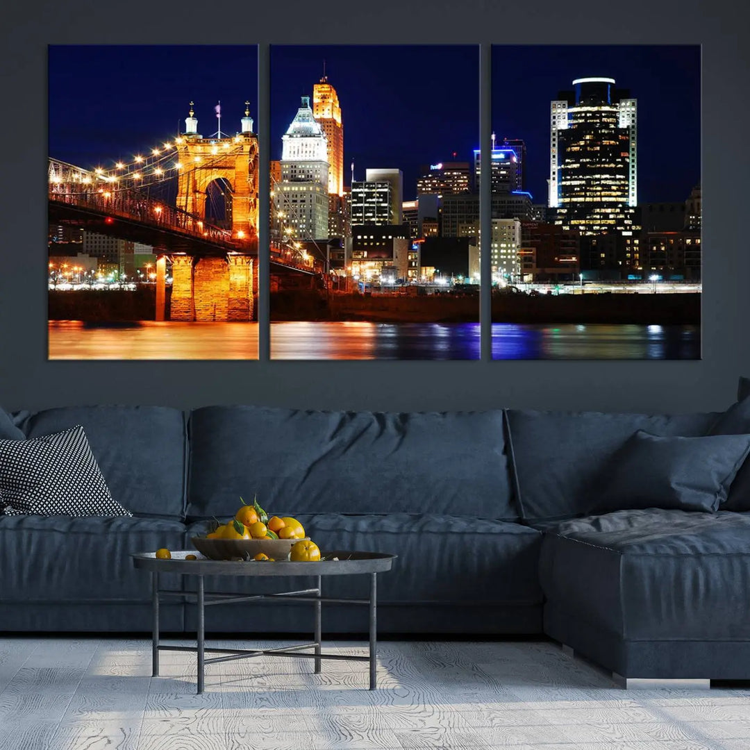 The Cincinnati City Lights Night Skyline Cityscape View Wall Art Canvas Print showcases a stunning night view of a city skyline with an illuminated bridge, making it an ideal museum-quality addition.