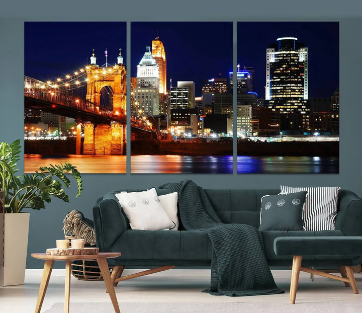 The Cincinnati City Lights Night Skyline Cityscape View Wall Art Canvas Print showcases a stunning night view of a city skyline with an illuminated bridge, making it an ideal museum-quality addition.