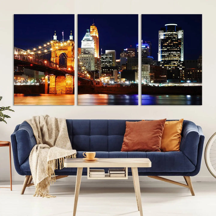 The Cincinnati City Lights Night Skyline Cityscape View Wall Art Canvas Print showcases a stunning night view of a city skyline with an illuminated bridge, making it an ideal museum-quality addition.