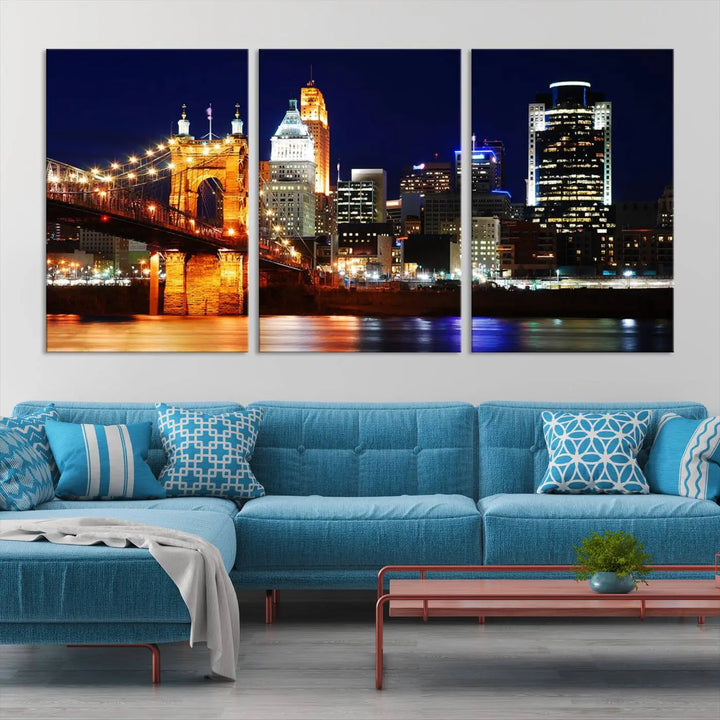 The Cincinnati City Lights Night Skyline Cityscape View Wall Art Canvas Print showcases a stunning night view of a city skyline with an illuminated bridge, making it an ideal museum-quality addition.