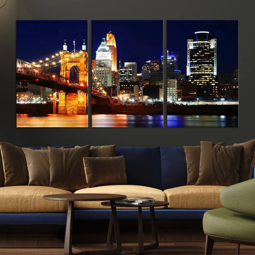 The Cincinnati City Lights Night Skyline Cityscape View Wall Art Canvas Print showcases a stunning night view of a city skyline with an illuminated bridge, making it an ideal museum-quality addition.