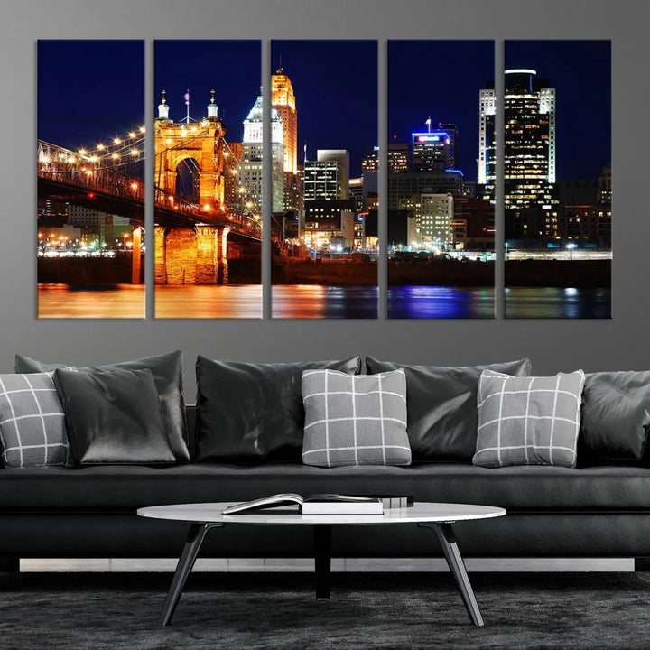 The Cincinnati City Lights Night Skyline Cityscape View Wall Art Canvas Print showcases a stunning night view of a city skyline with an illuminated bridge, making it an ideal museum-quality addition.