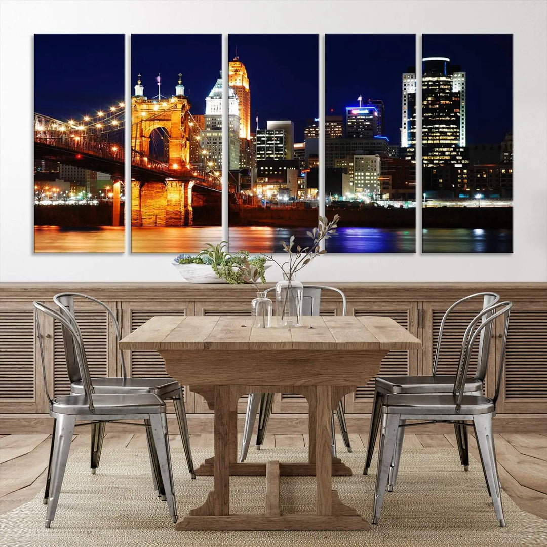 The Cincinnati City Lights Night Skyline Cityscape View Wall Art Canvas Print showcases a stunning night view of a city skyline with an illuminated bridge, making it an ideal museum-quality addition.