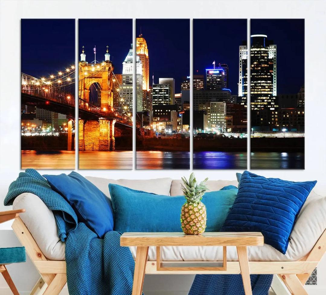 The Cincinnati City Lights Night Skyline Cityscape View Wall Art Canvas Print showcases a stunning night view of a city skyline with an illuminated bridge, making it an ideal museum-quality addition.