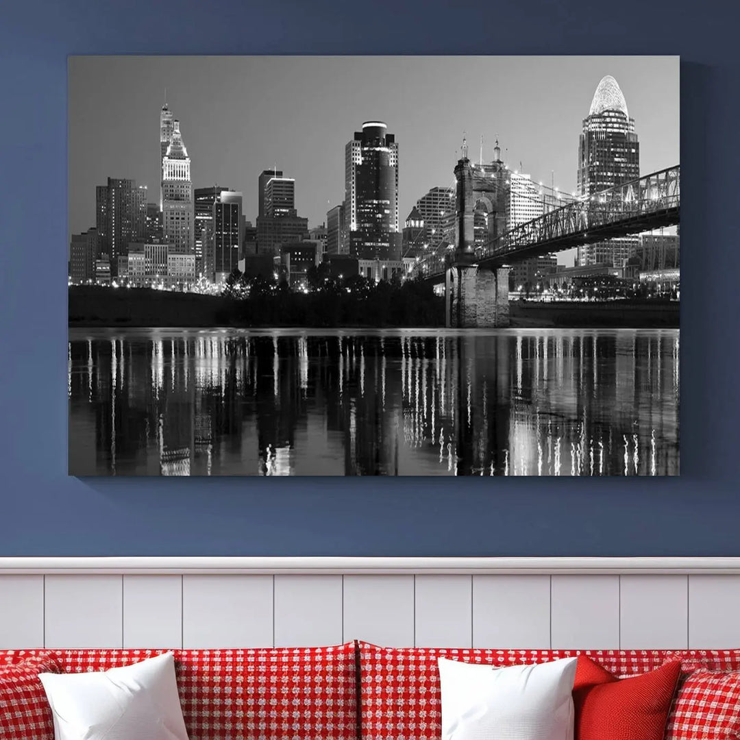 The wall showcases a ready-to-hang triptych of the Cincinnati City Lights Skyline in black and white, printed on museum-quality canvas.