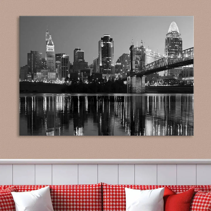 The wall showcases a ready-to-hang triptych of the Cincinnati City Lights Skyline in black and white, printed on museum-quality canvas.