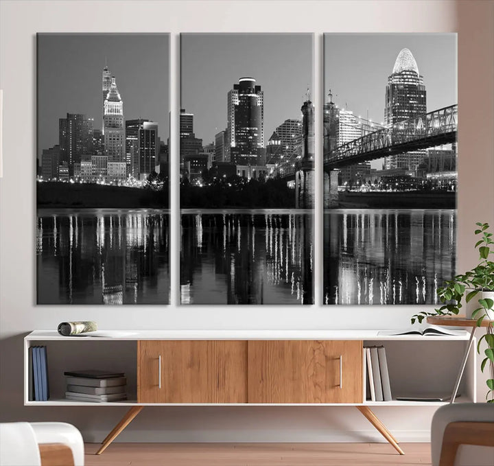 The wall showcases a ready-to-hang triptych of the Cincinnati City Lights Skyline in black and white, printed on museum-quality canvas.