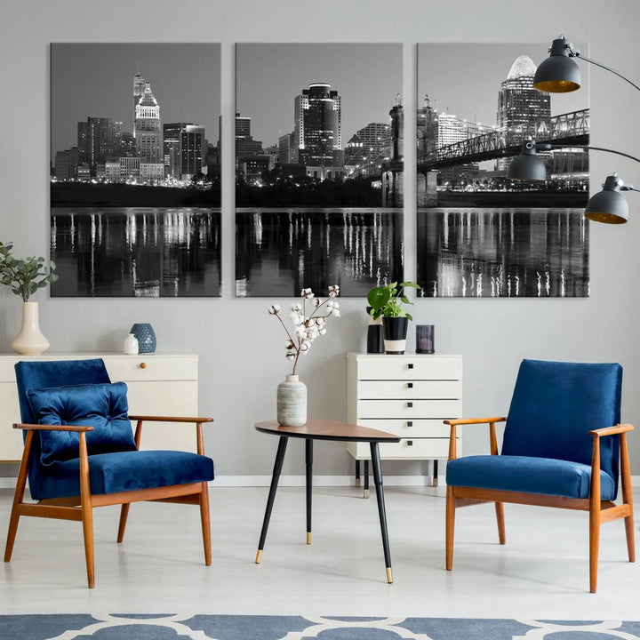 The wall showcases a ready-to-hang triptych of the Cincinnati City Lights Skyline in black and white, printed on museum-quality canvas.