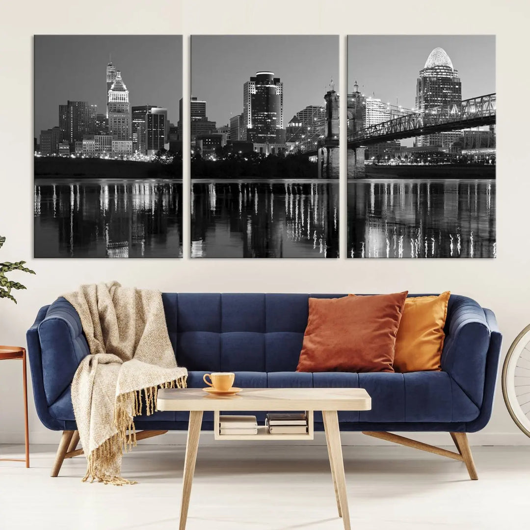 The wall showcases a ready-to-hang triptych of the Cincinnati City Lights Skyline in black and white, printed on museum-quality canvas.