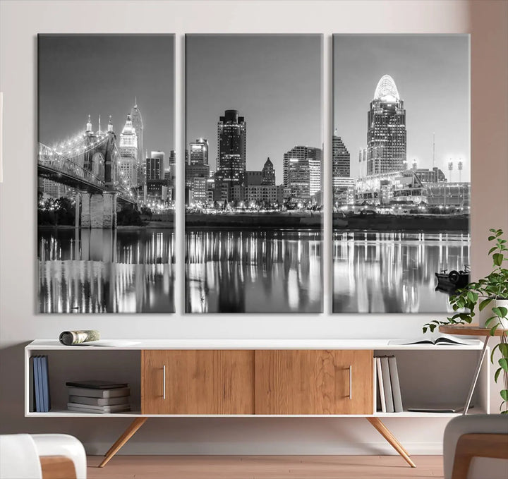 The "Cincinnati City Lights Skyline Black and White Wall Art Cityscape Canvas Print" is elegantly displayed in a stylish living room.