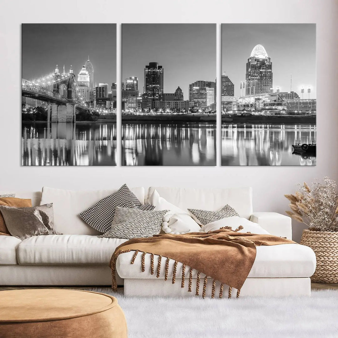 The "Cincinnati City Lights Skyline Black and White Wall Art Cityscape Canvas Print" is elegantly displayed in a stylish living room.