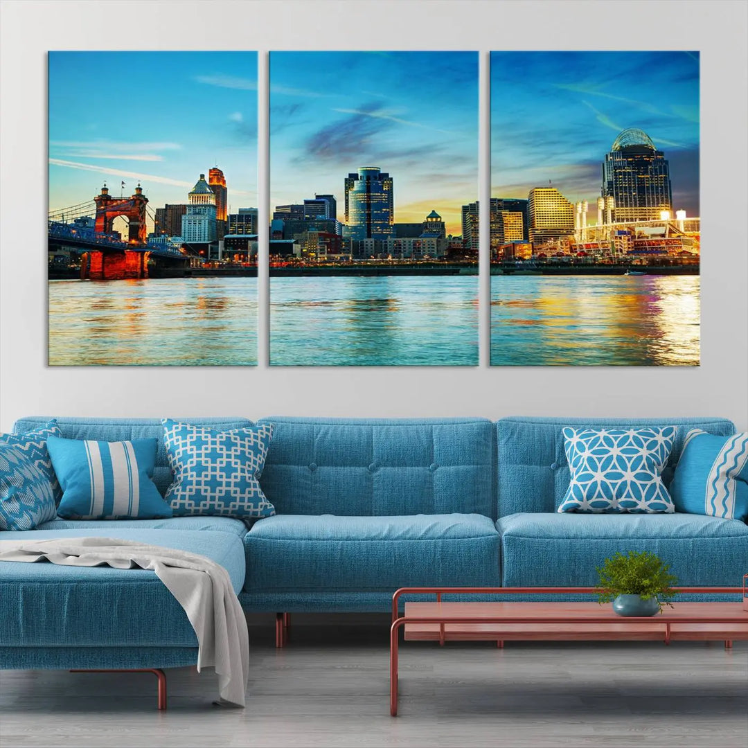 A triptych titled "Cincinnati City Lights Sunset Bright Blue Skyline Cityscape View Wall Art Canvas Print" is showcased, each canvas expertly crafted with museum-quality precision on a stretched wood frame.