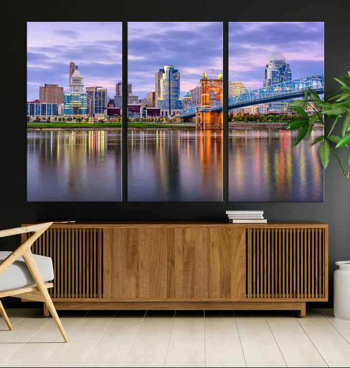 The room features the Cincinnati City Lights Sunset Purple Cloudy Skyline Cityscape View Wall Art Canvas Print, showcasing a breathtaking skyline reflecting on the river. Each piece is created with museum-quality canvas, includes UV-protective coating, and comes ready to hang.