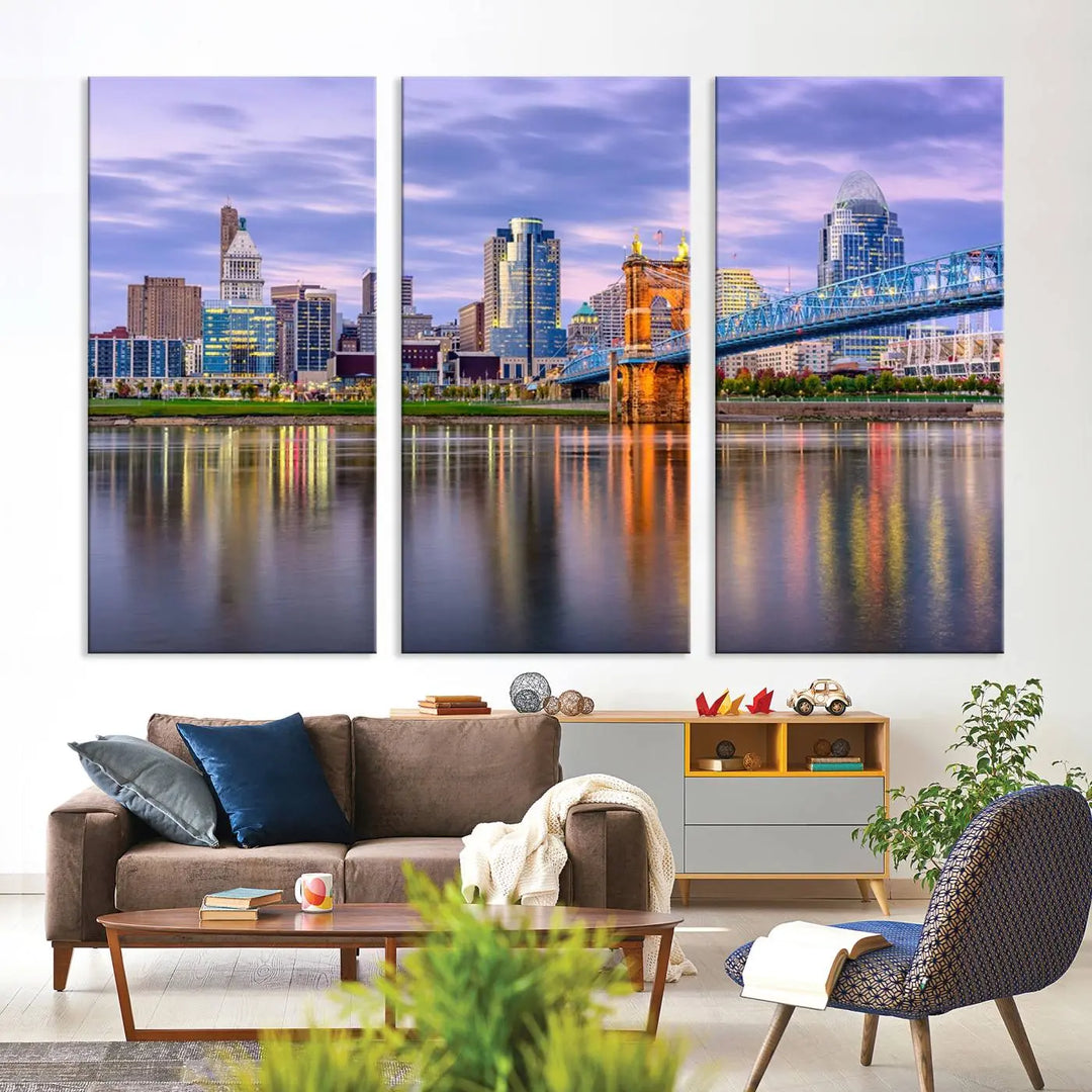 The room features the Cincinnati City Lights Sunset Purple Cloudy Skyline Cityscape View Wall Art Canvas Print, showcasing a breathtaking skyline reflecting on the river. Each piece is created with museum-quality canvas, includes UV-protective coating, and comes ready to hang.