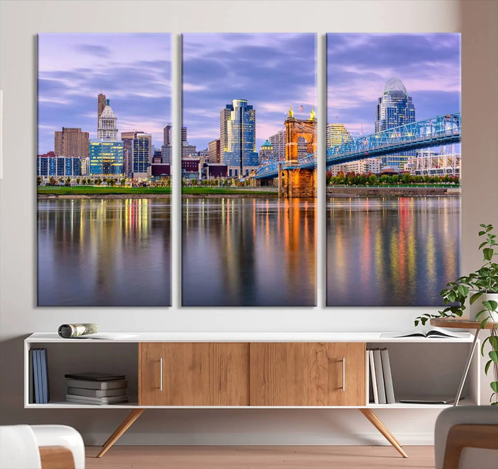 The room features the Cincinnati City Lights Sunset Purple Cloudy Skyline Cityscape View Wall Art Canvas Print, showcasing a breathtaking skyline reflecting on the river. Each piece is created with museum-quality canvas, includes UV-protective coating, and comes ready to hang.