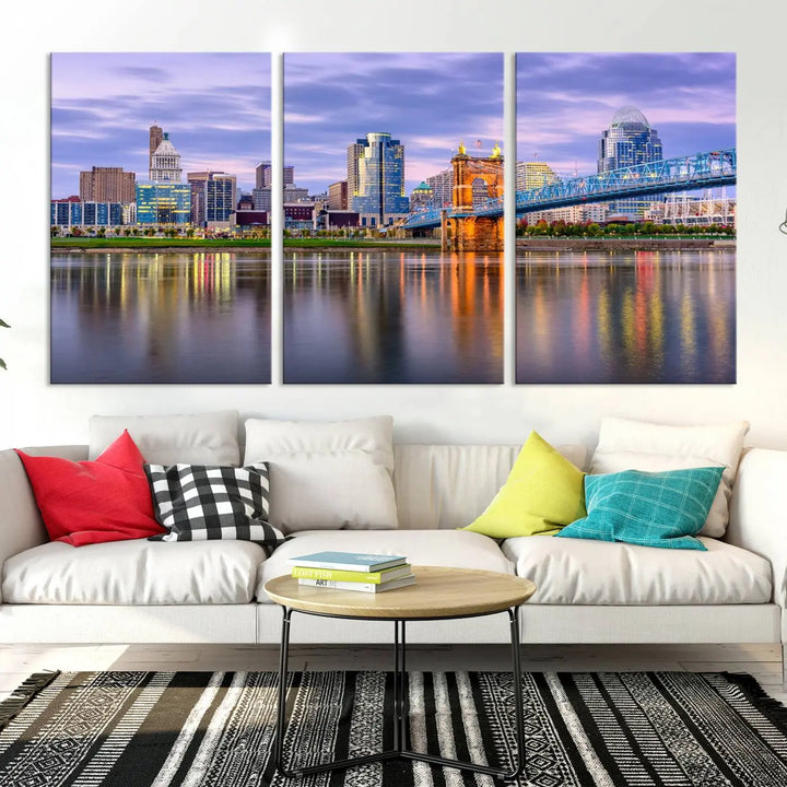 The room features the Cincinnati City Lights Sunset Purple Cloudy Skyline Cityscape View Wall Art Canvas Print, showcasing a breathtaking skyline reflecting on the river. Each piece is created with museum-quality canvas, includes UV-protective coating, and comes ready to hang.