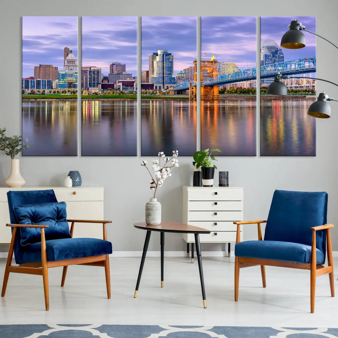 The room features the Cincinnati City Lights Sunset Purple Cloudy Skyline Cityscape View Wall Art Canvas Print, showcasing a breathtaking skyline reflecting on the river. Each piece is created with museum-quality canvas, includes UV-protective coating, and comes ready to hang.