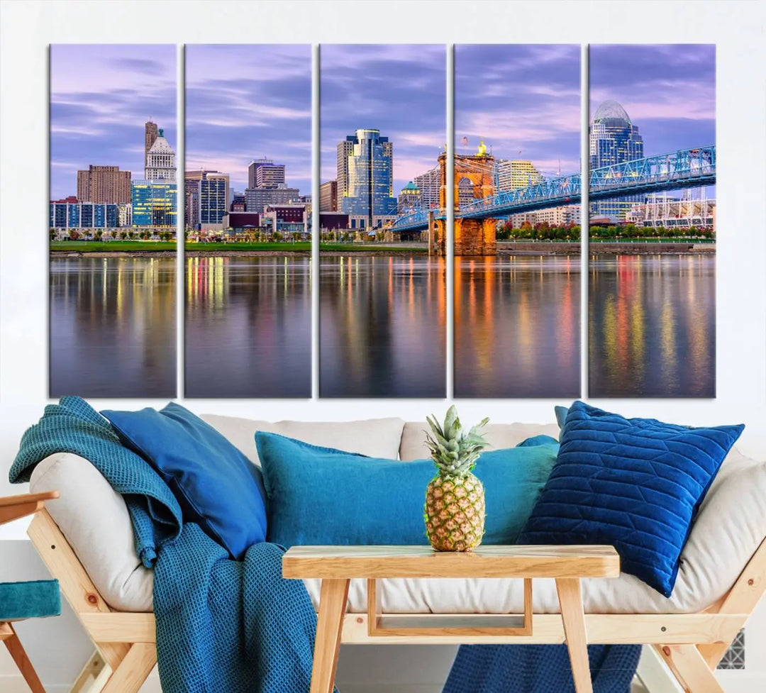 The room features the Cincinnati City Lights Sunset Purple Cloudy Skyline Cityscape View Wall Art Canvas Print, showcasing a breathtaking skyline reflecting on the river. Each piece is created with museum-quality canvas, includes UV-protective coating, and comes ready to hang.