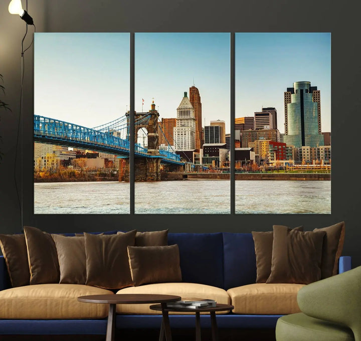 The Cincinnati City Morning Skyline Cityscape View Wall Art Canvas Print features three-panel museum-quality canvases depicting a city skyline with a bridge over a river. This gallery-wrapped artwork ensures an elegant finish and enduring beauty.