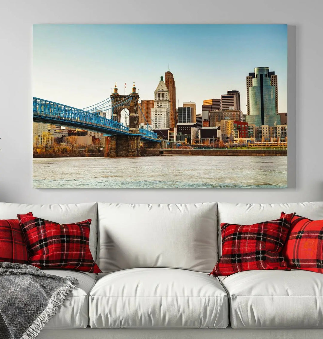 The Cincinnati City Morning Skyline Cityscape View Wall Art Canvas Print features three-panel museum-quality canvases depicting a city skyline with a bridge over a river. This gallery-wrapped artwork ensures an elegant finish and enduring beauty.