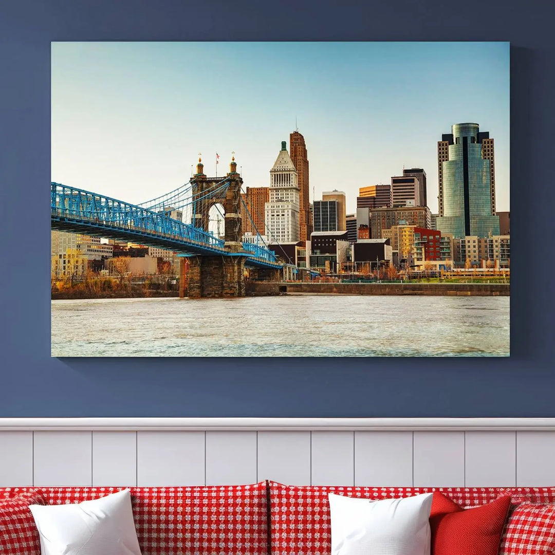 The Cincinnati City Morning Skyline Cityscape View Wall Art Canvas Print features three-panel museum-quality canvases depicting a city skyline with a bridge over a river. This gallery-wrapped artwork ensures an elegant finish and enduring beauty.