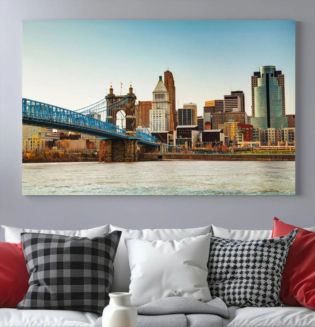 The Cincinnati City Morning Skyline Cityscape View Wall Art Canvas Print features three-panel museum-quality canvases depicting a city skyline with a bridge over a river. This gallery-wrapped artwork ensures an elegant finish and enduring beauty.