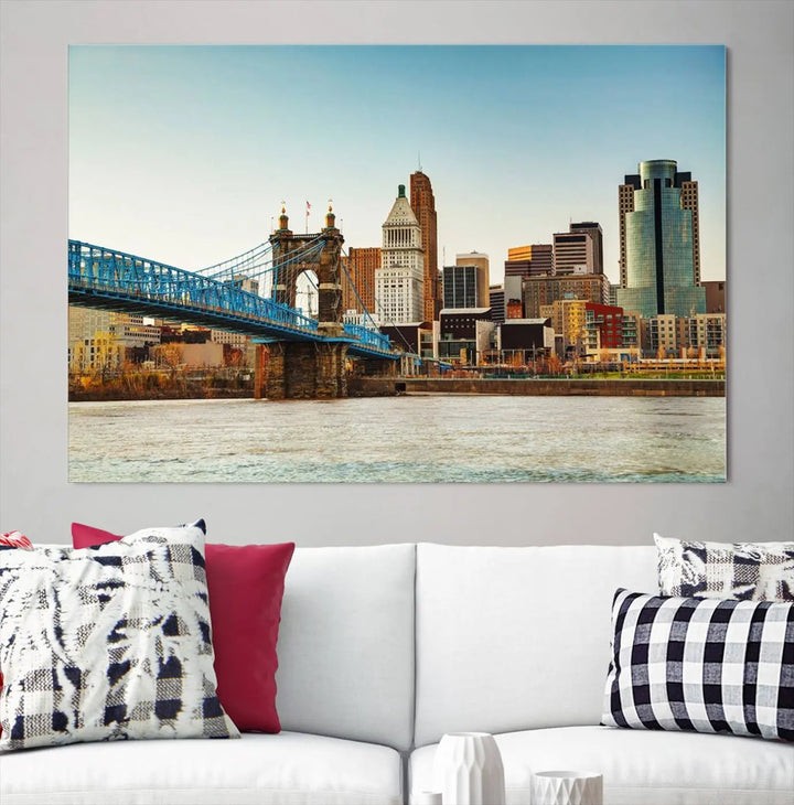 The Cincinnati City Morning Skyline Cityscape View Wall Art Canvas Print features three-panel museum-quality canvases depicting a city skyline with a bridge over a river. This gallery-wrapped artwork ensures an elegant finish and enduring beauty.