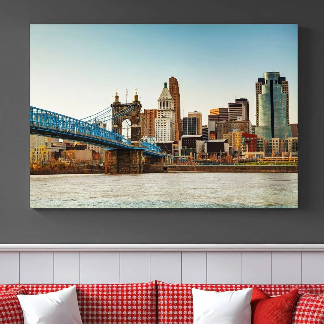 The Cincinnati City Morning Skyline Cityscape View Wall Art Canvas Print features three-panel museum-quality canvases depicting a city skyline with a bridge over a river. This gallery-wrapped artwork ensures an elegant finish and enduring beauty.