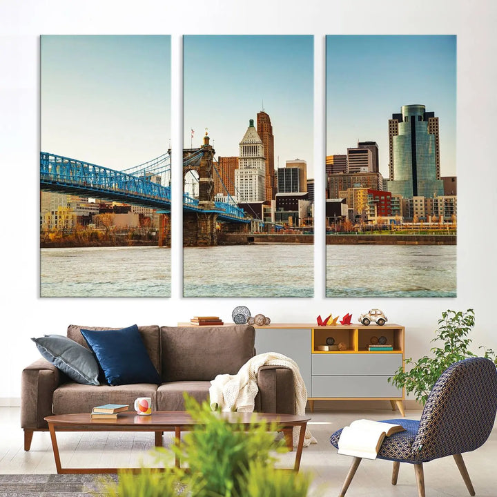 The Cincinnati City Morning Skyline Cityscape View Wall Art Canvas Print features three-panel museum-quality canvases depicting a city skyline with a bridge over a river. This gallery-wrapped artwork ensures an elegant finish and enduring beauty.