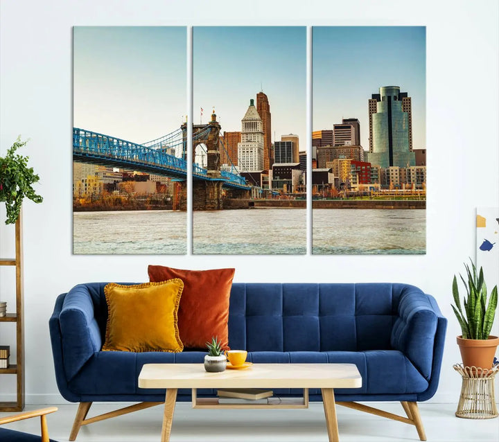 The Cincinnati City Morning Skyline Cityscape View Wall Art Canvas Print features three-panel museum-quality canvases depicting a city skyline with a bridge over a river. This gallery-wrapped artwork ensures an elegant finish and enduring beauty.