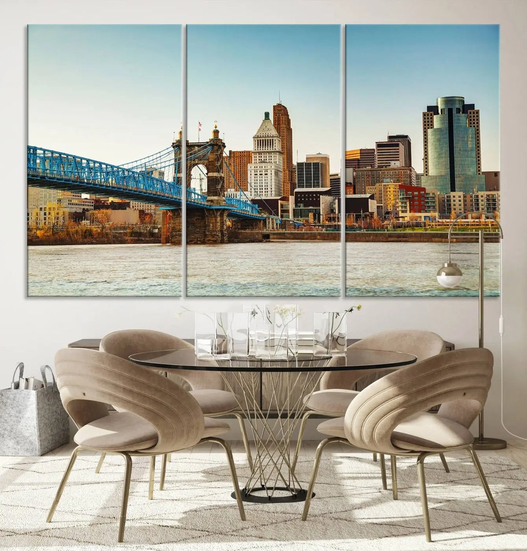 The Cincinnati City Morning Skyline Cityscape View Wall Art Canvas Print features three-panel museum-quality canvases depicting a city skyline with a bridge over a river. This gallery-wrapped artwork ensures an elegant finish and enduring beauty.