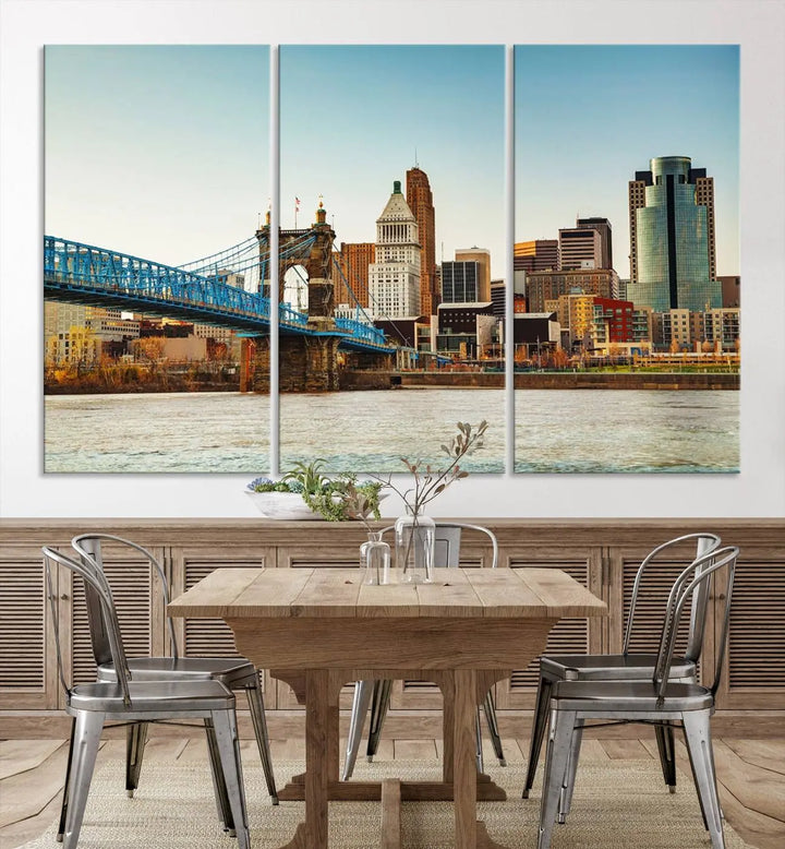 The Cincinnati City Morning Skyline Cityscape View Wall Art Canvas Print features three-panel museum-quality canvases depicting a city skyline with a bridge over a river. This gallery-wrapped artwork ensures an elegant finish and enduring beauty.