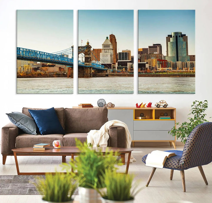 The Cincinnati City Morning Skyline Cityscape View Wall Art Canvas Print features three-panel museum-quality canvases depicting a city skyline with a bridge over a river. This gallery-wrapped artwork ensures an elegant finish and enduring beauty.