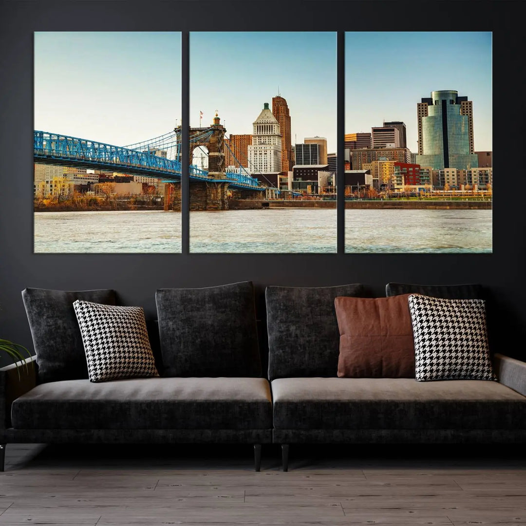 The Cincinnati City Morning Skyline Cityscape View Wall Art Canvas Print features three-panel museum-quality canvases depicting a city skyline with a bridge over a river. This gallery-wrapped artwork ensures an elegant finish and enduring beauty.