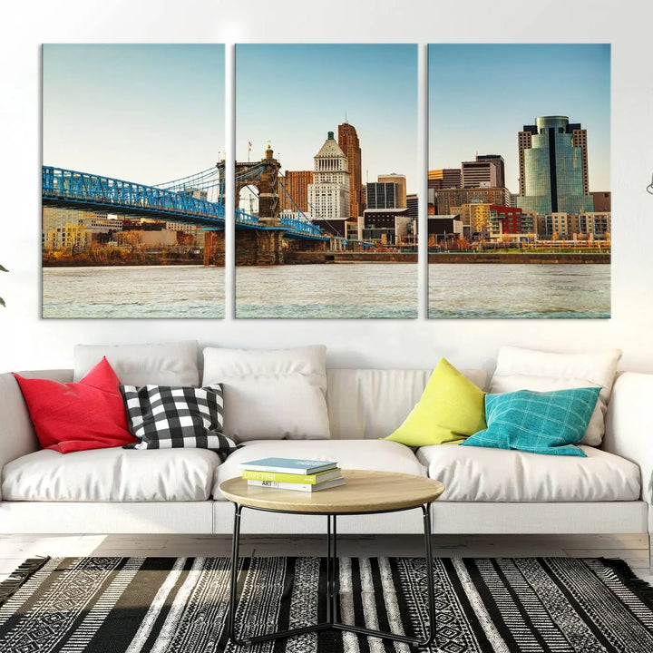 The Cincinnati City Morning Skyline Cityscape View Wall Art Canvas Print features three-panel museum-quality canvases depicting a city skyline with a bridge over a river. This gallery-wrapped artwork ensures an elegant finish and enduring beauty.