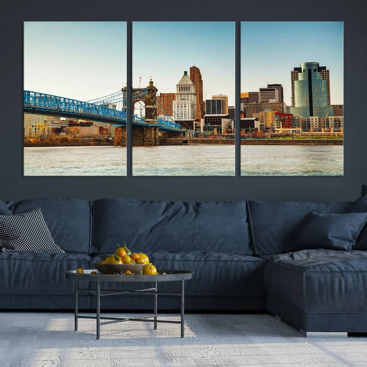 The Cincinnati City Morning Skyline Cityscape View Wall Art Canvas Print features three-panel museum-quality canvases depicting a city skyline with a bridge over a river. This gallery-wrapped artwork ensures an elegant finish and enduring beauty.