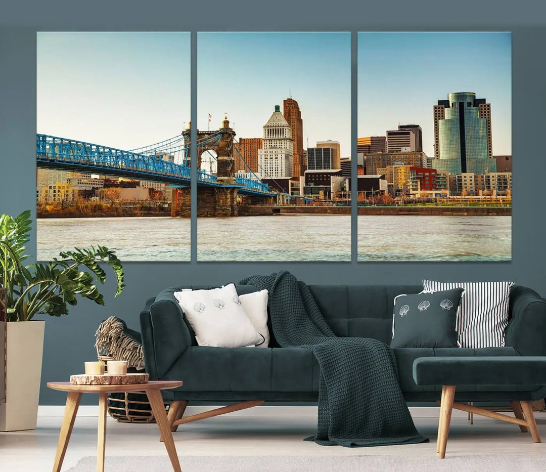 The Cincinnati City Morning Skyline Cityscape View Wall Art Canvas Print features three-panel museum-quality canvases depicting a city skyline with a bridge over a river. This gallery-wrapped artwork ensures an elegant finish and enduring beauty.