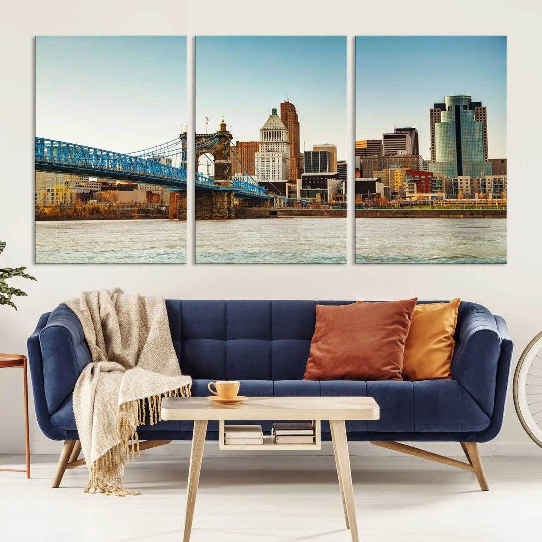 The Cincinnati City Morning Skyline Cityscape View Wall Art Canvas Print features three-panel museum-quality canvases depicting a city skyline with a bridge over a river. This gallery-wrapped artwork ensures an elegant finish and enduring beauty.