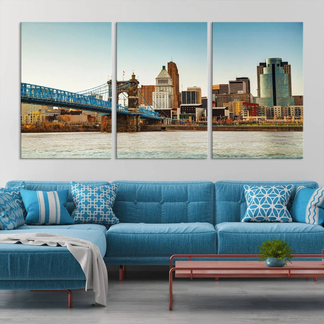 The Cincinnati City Morning Skyline Cityscape View Wall Art Canvas Print features three-panel museum-quality canvases depicting a city skyline with a bridge over a river. This gallery-wrapped artwork ensures an elegant finish and enduring beauty.